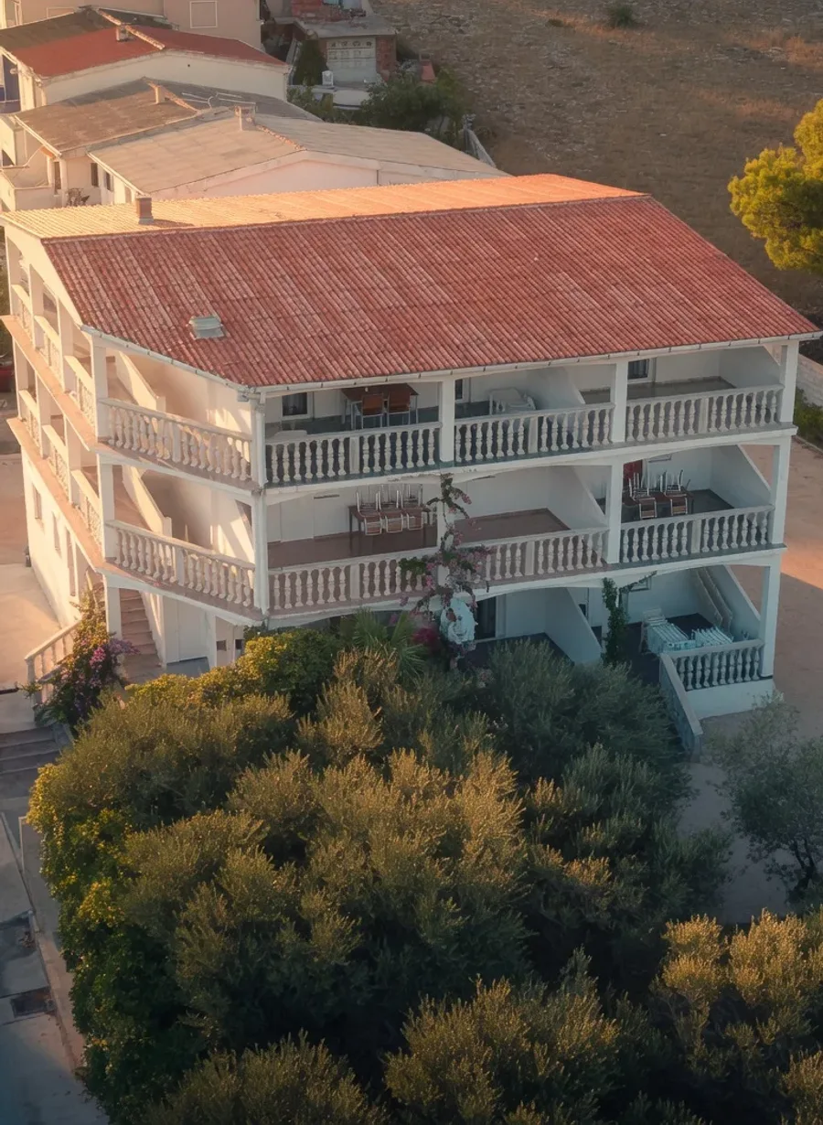 Kuća s apartmanima Babsy u Povljani, s balkonima i maslinama, u zlatnom večernjem svjetlu